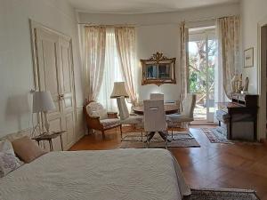 a bedroom with a bed and a desk and a table at Romantic Studio Center in Colmar