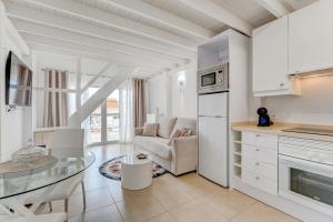 a kitchen and living room with a glass table at Yucca Park Apartment in Adeje