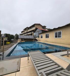 a large swimming pool in front of a building at Regenta Z Mahabaleshwar in Mahabaleshwar