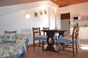 a kitchen and dining room with a table and chairs at Viola Istra Guest House in Štinjan +102 photos
