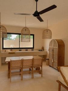 eine Küche mit einem Tisch und Stühlen sowie einem Deckenventilator in der Unterkunft BAYA - Modern & Cozy 2BR Villa Uluwatu in Bingin Beach