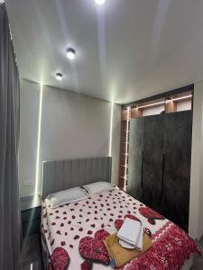 a bedroom with a large bed with flowers on it at BeST TRIP in Almaty +1 photo