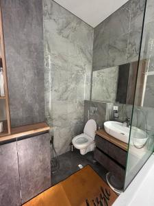 a bathroom with a toilet and a sink at BeST TRIP in Almaty