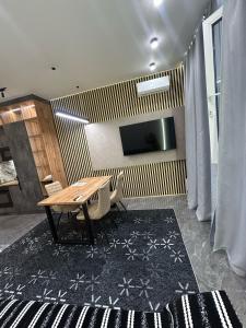 a dining room with a table and a tv at BeST TRIP in Almaty