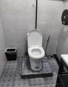a bathroom with a toilet in a stall at OK hostel in Luang Prabang