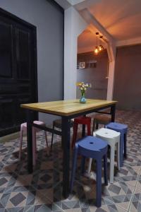 a wooden table with chairs and a vase of flowers on it at OK hostel in Luang Prabang