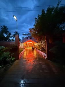 a house with a lighted driveway in front of it at Gyani 3 in Tiruvannāmalai
