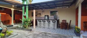 a patio with a bar in a house at marvin's guesthouse in Lovina