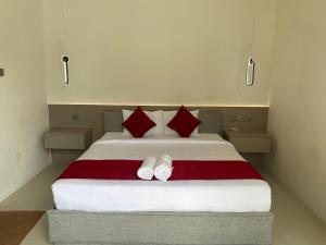 a bedroom with a large bed with red pillows at Villa Dewi Sri by MentariPro Bali in Buleleng