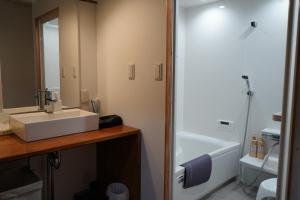 a bathroom with a sink and a toilet and a shower at KOMINKA T8 Tomonoura in Fukuyama