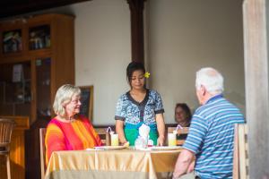 a group of people sitting at a table at Pondok Baruna Garden in Nusa Lembongan