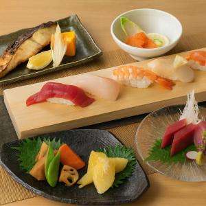 a table with plates of different types of sushi at YMK Oshiage 5B in Tokyo