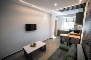 a living room with a couch and a table at Coloris Viridis room in Thessaloniki