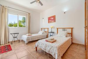 a bedroom with two beds and a window at Villa Las Brisas in Salobreña +24 photos
