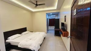 a bedroom with a bed and a ceiling fan at Claudina baga beach in Calangute
