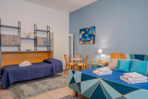 a bedroom with a bed and a table and a chair at Da NOI A TRIESTE in Trieste