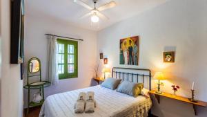 a bedroom with a bed with two pairs of shoes on it at Casa El Torin Frigiliana by Ruralidays in Frigiliana +27 photos