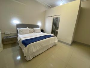 a bedroom with a large white bed in a room at JH Guest house in Durban +15 photos