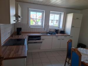 a kitchen with a sink and a refrigerator at Ferienwohnung Schönhals in Hochwaldhausen