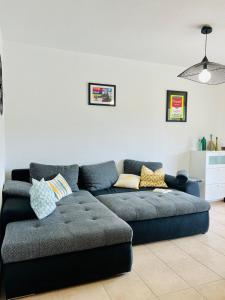 a living room with a blue couch in a room at appartement au coeur de Saint-Florent à 200m de la plage in Saint-Florent