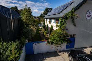 a house with solar panels on the roof at Domki Kurka Wodna in Dębki +47 photos