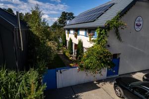 a house with solar panels on the roof at Domki Kurka Wodna in Dębki