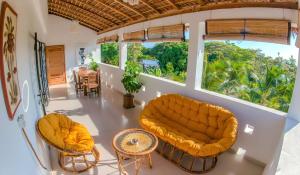 a living room with a couch and a table at belle villa neuve à NOSY BE Ambaro avec 4 chambres in Ambaro