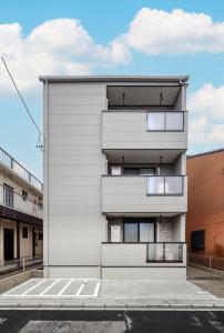 an apartment building with balconies on the side of it at Anecis Honjin in Nagoya