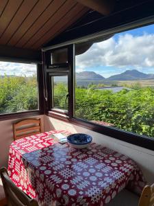 a table in a room with a view of the mountains at Eryri Retreat in Trawsfynydd