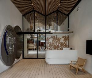 a room with a table and a chair and a window at Double B Hostel in Bangkok