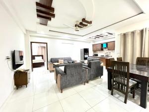 a living room with a couch and a table at Luxury Apartment Guest House in Islamabad