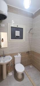 a bathroom with a toilet and a sink at 207 , viva coast resort in Ain Sokhna