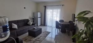a living room with a couch and a table at 207 , viva coast resort in Ain Sokhna