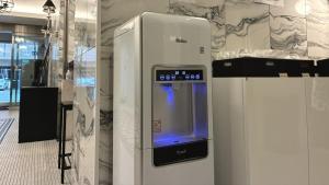 a machine with a screen on the side of a room at Amistad Hotel Fukuoka in Fukuoka