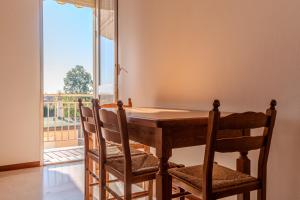 a dining room table with chairs and a large window at Road to Venice M&N Dolo Apartment in Dolo +8 photos