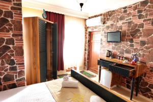 a hotel room with a brick wall at Cappadocia Hostel in Goreme