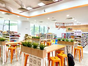 a store with tables and chairs and plants in it at Summer Suites Best Western Home Klcc in Kuala Lumpur