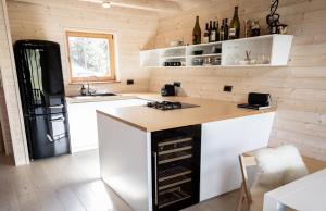 a kitchen with a black and white refrigerator and a counter at Chalet Aurora in Kanji Dol