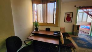 a room with a desk and a table and chairs at Private Room Central, Quite & Beautiful Flat in Cairo +2 photos