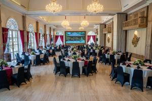 a banquet hall with tables and chairs and chandeliers at Plataran Heritage Borobudur Hotel in Borobudur +66 photos