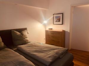 a small bedroom with a bed and a dresser at Familienapartment in Bad Orb