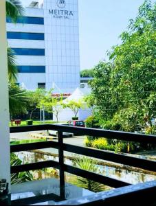 a view from a balcony of a building with a pond at Garden view home stay for family near meitra hospital in Kozhikode