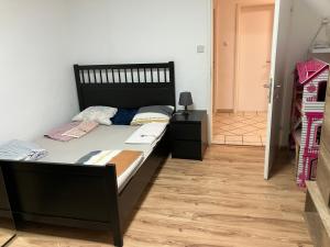a bed in a room with a wooden floor at Rooms for rent in high valley Bad Bleiberg in Bad Bleiberg +7 photos