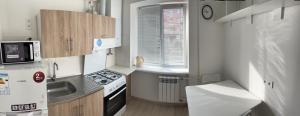 a small kitchen with a sink and a stove at Полтава Поділ по добова оренда in Poltava