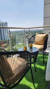 a patio with a table and chairs on a balcony at Erick Homes in Ruiru