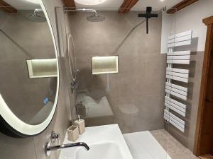a bathroom with a sink and a mirror at RitterLiving Ferienapartment am Markt in Tangermünde