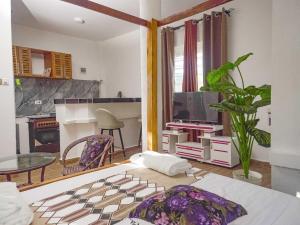 a living room with a table and a tv at Escape Hole in Diani Beach