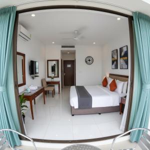 a hotel room with a bed and a desk at Kamal bliss resort in Karjat