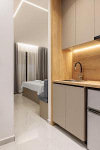 a kitchen with a sink and a bed in a room at Dialetti's Nook In Ελλάδα in Thessaloniki