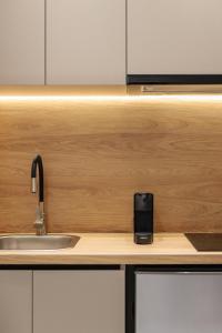 a kitchen counter with a sink and a counter top with a sink at Dialetti's Nook In Ελλάδα in Thessaloniki